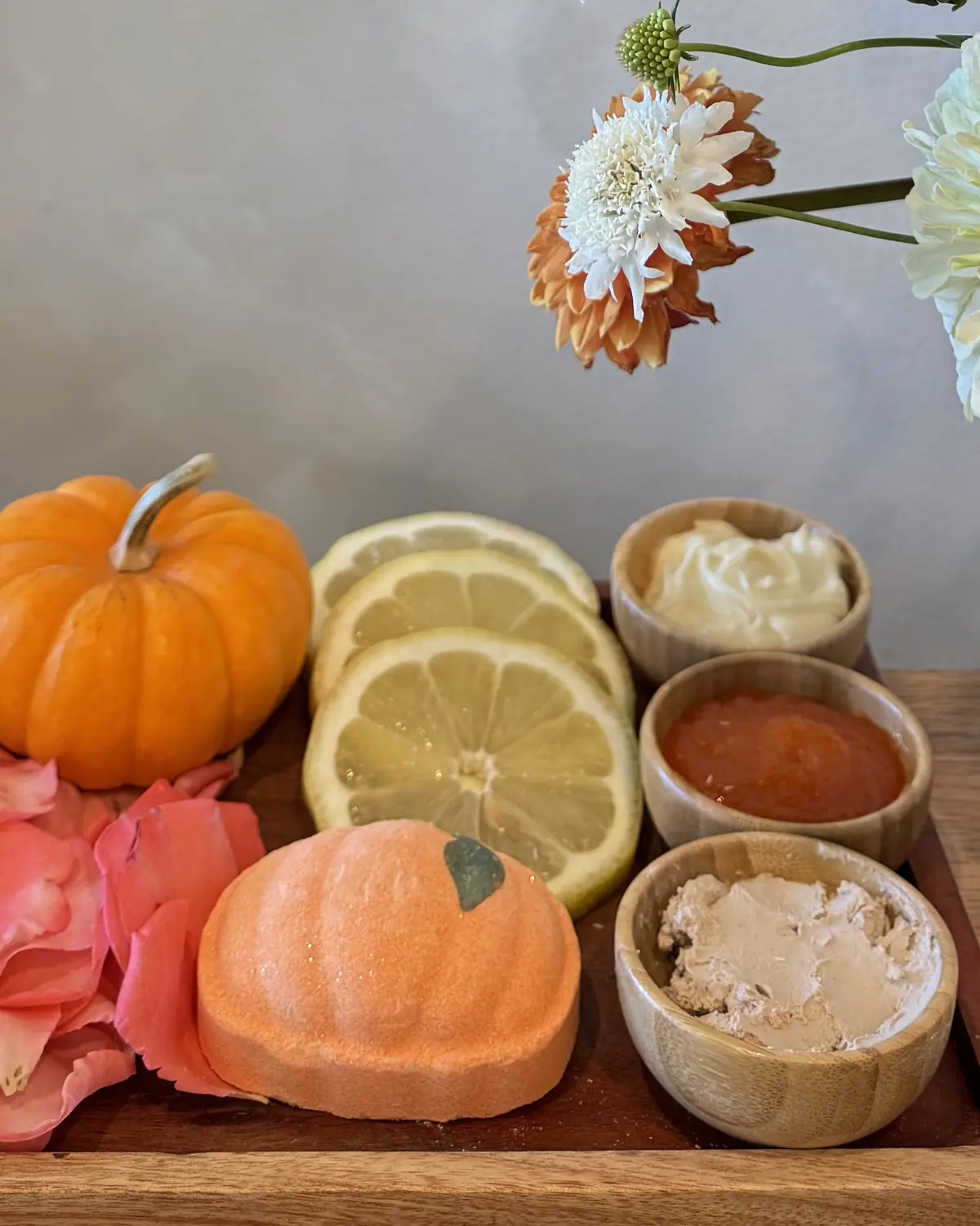 Pumpkin Spice Pedicure ingredients - mini pumpkin, lemon slices, pumpkin bath bomb and scrub bowls at Pinko Nails & Spa