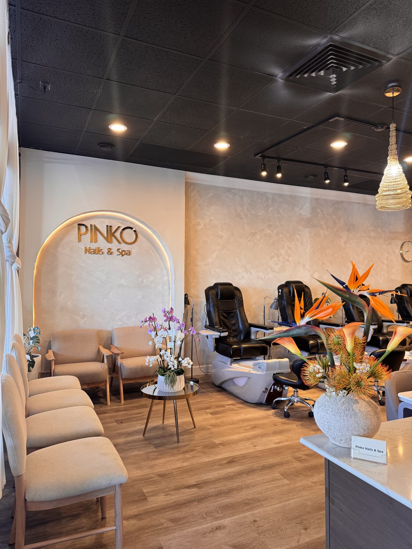 Lounge seating beside pedicure chairs at Pinko Nails & Spa.