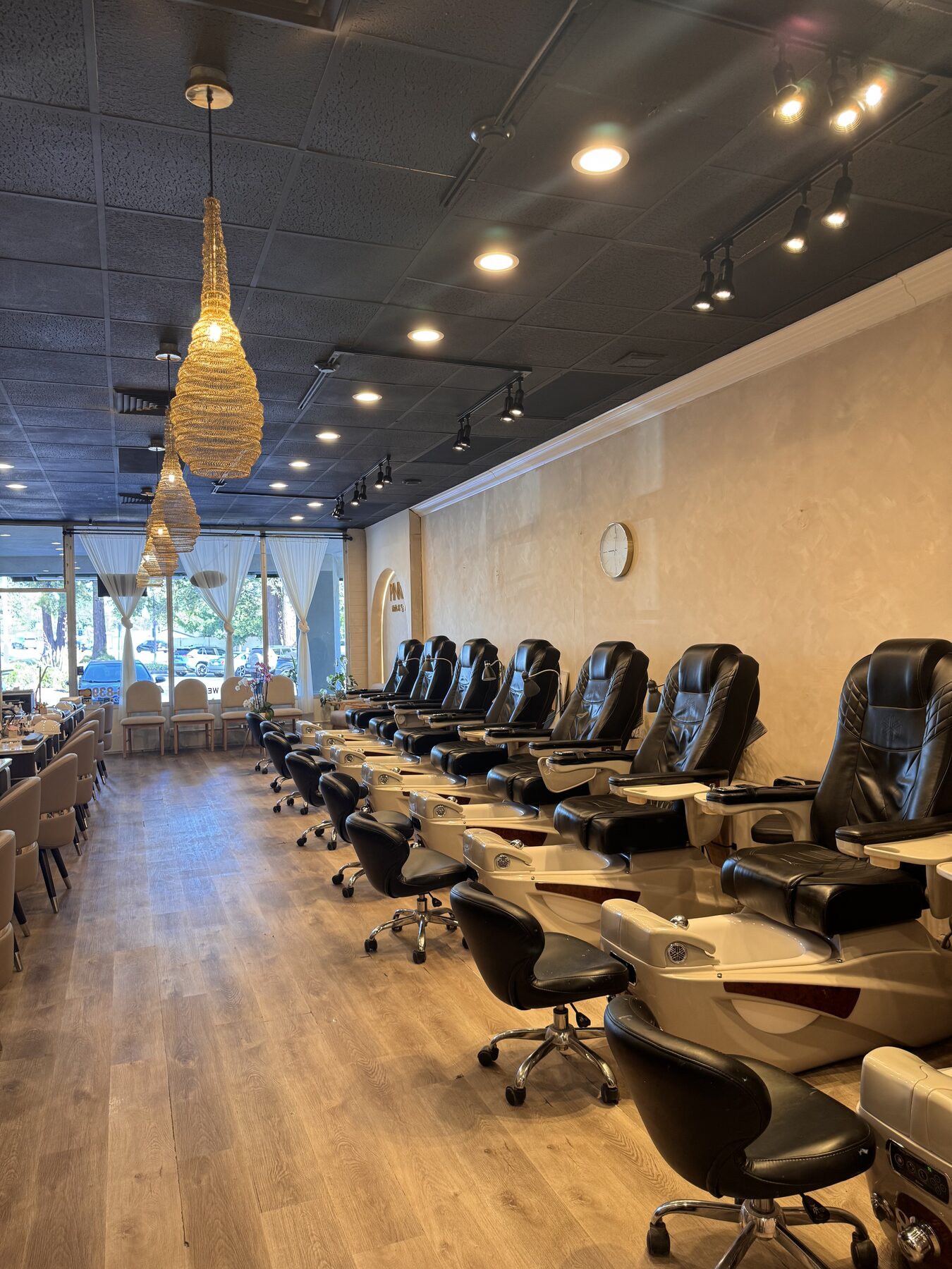 Wide view down the pedicure row toward the storefront windows.