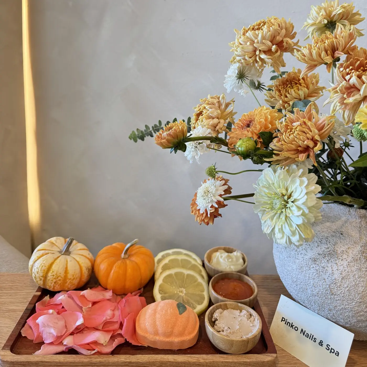 Pumpkin Spice Pedicure tray with mini pumpkins, lemon slices, rose petals and pumpkin scrub at Pinko Nails & Spa
