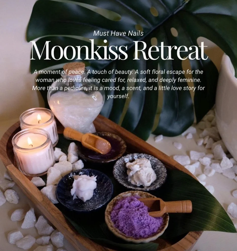 A wooden bowl with rose petals, sugar scrub and candles — the Moonkiss Retreat ritual